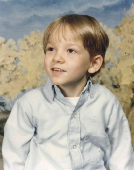 A young boy smiles in this portrait photo