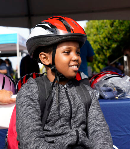 A boy in a bike helmet