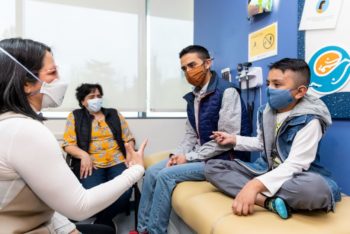 A mother and two boys talk to a doctor at Seattle Children's