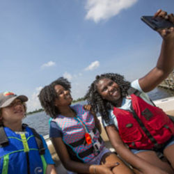 A family takes a selfie in a boat