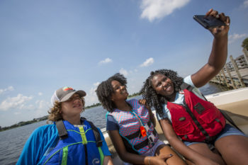 A family takes a selfie in a boat