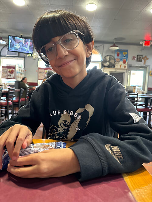 Smiling boy sitting at a table