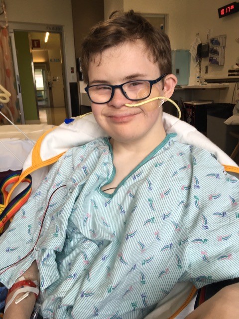 A teen patient smiles at the camera