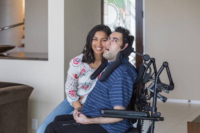 A smiling sister leans into her brother