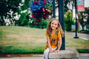 A girl poses for the camera outside