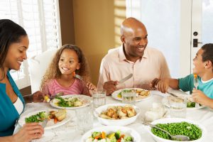 A family eats Thanksgiving together.