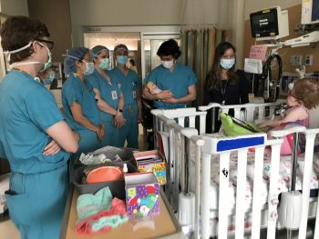 Doctors gathered around a crib