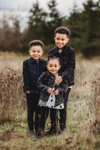 Three children standing in a field