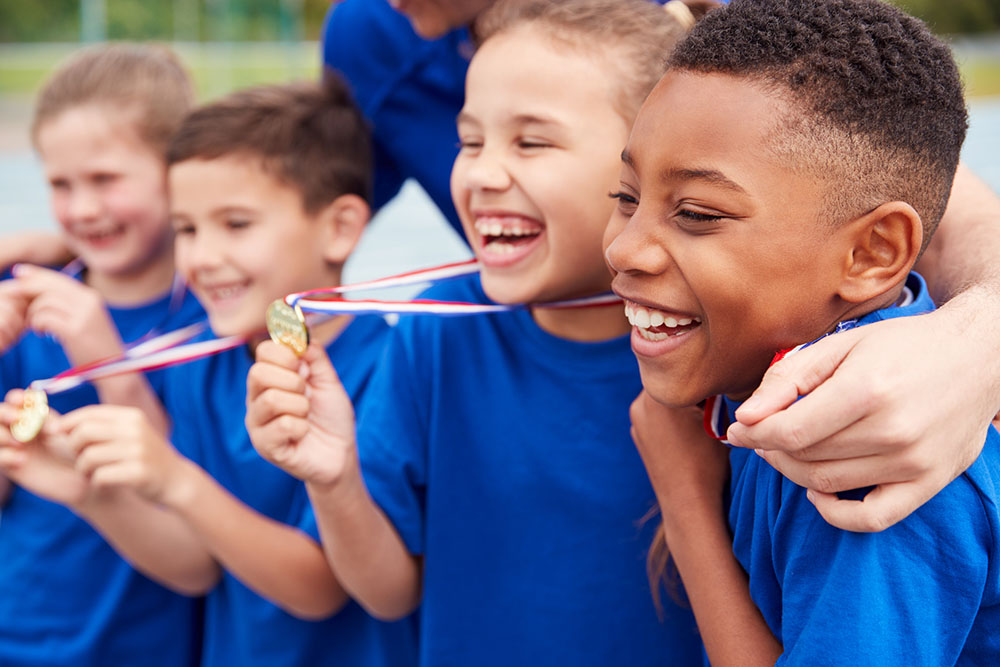 Children hold award medals