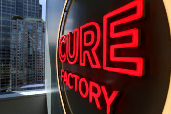 A sign that reads "Cure Factory"