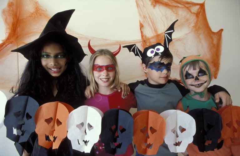 Kids pose together in their Halloween costumes.