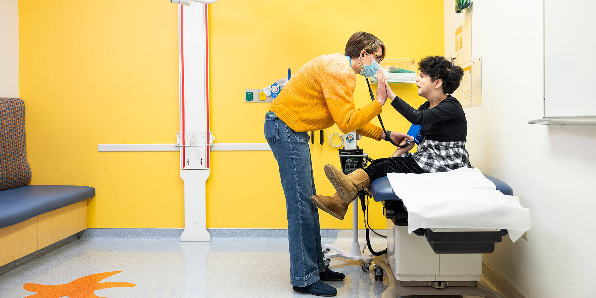 A Seattle Children's provider high-fives a patient