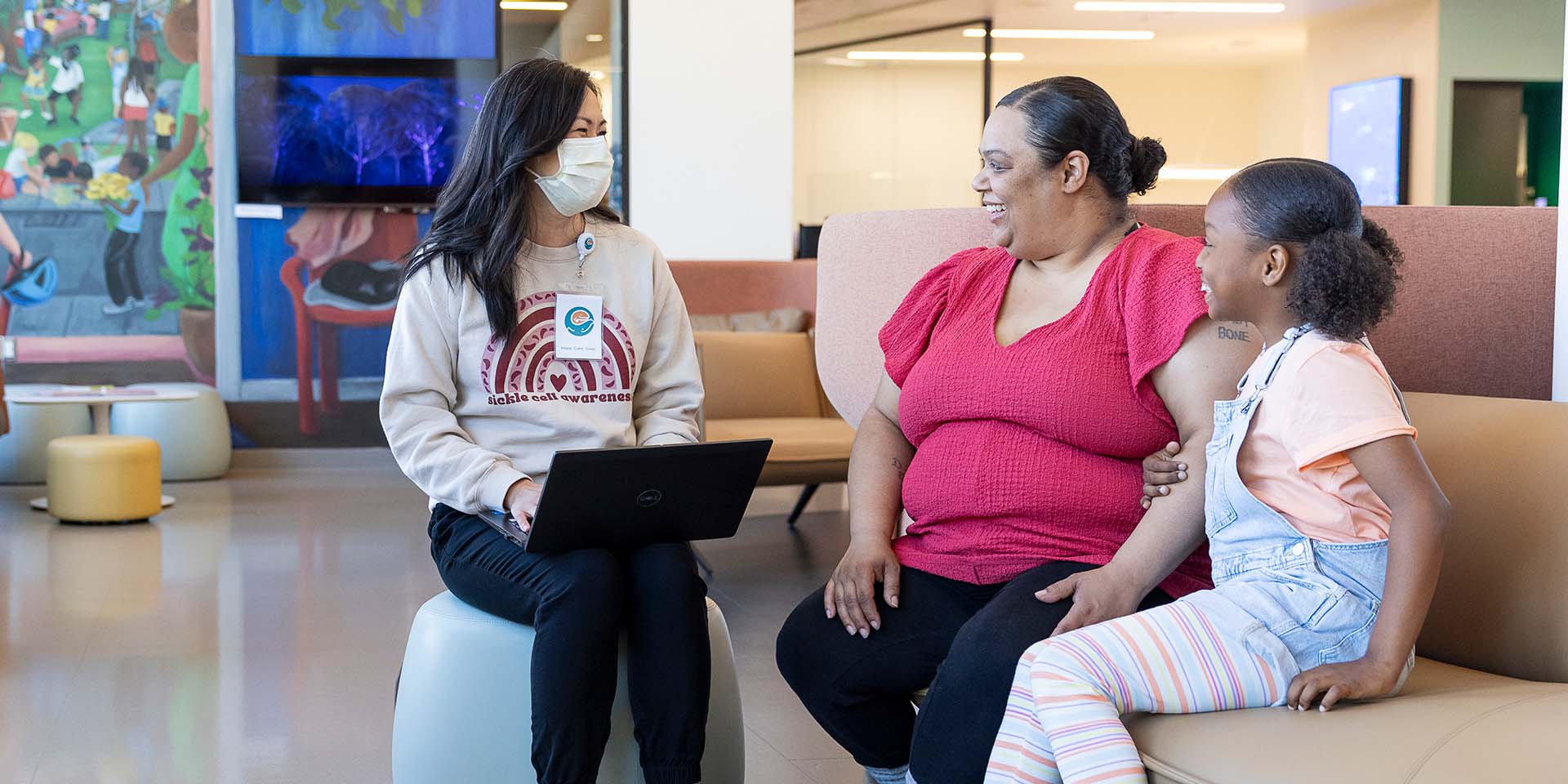 A Seattle Children's provider speaks to a mother and daughter