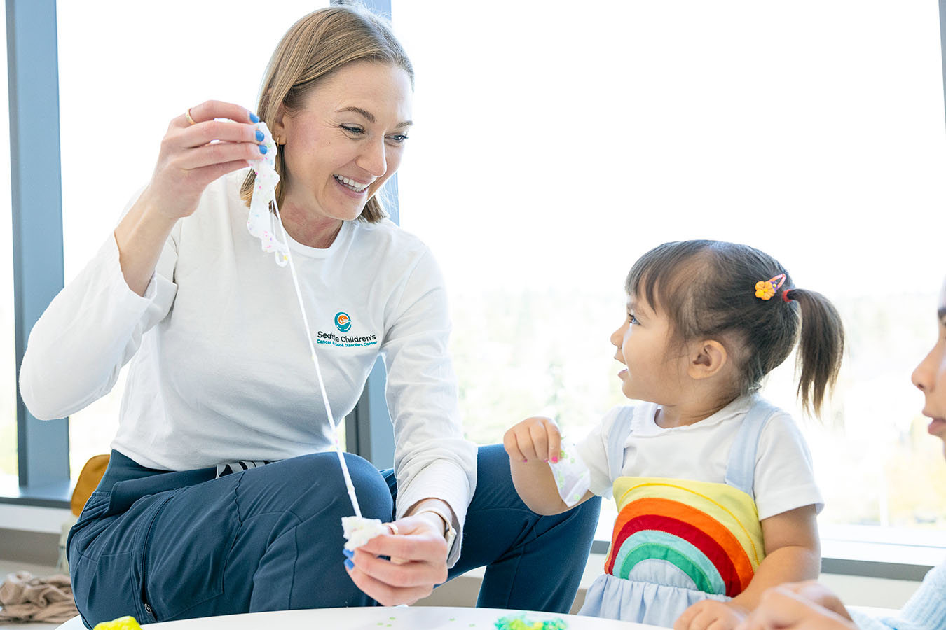 A Seattle Children's provider plays with a young leukemia patient