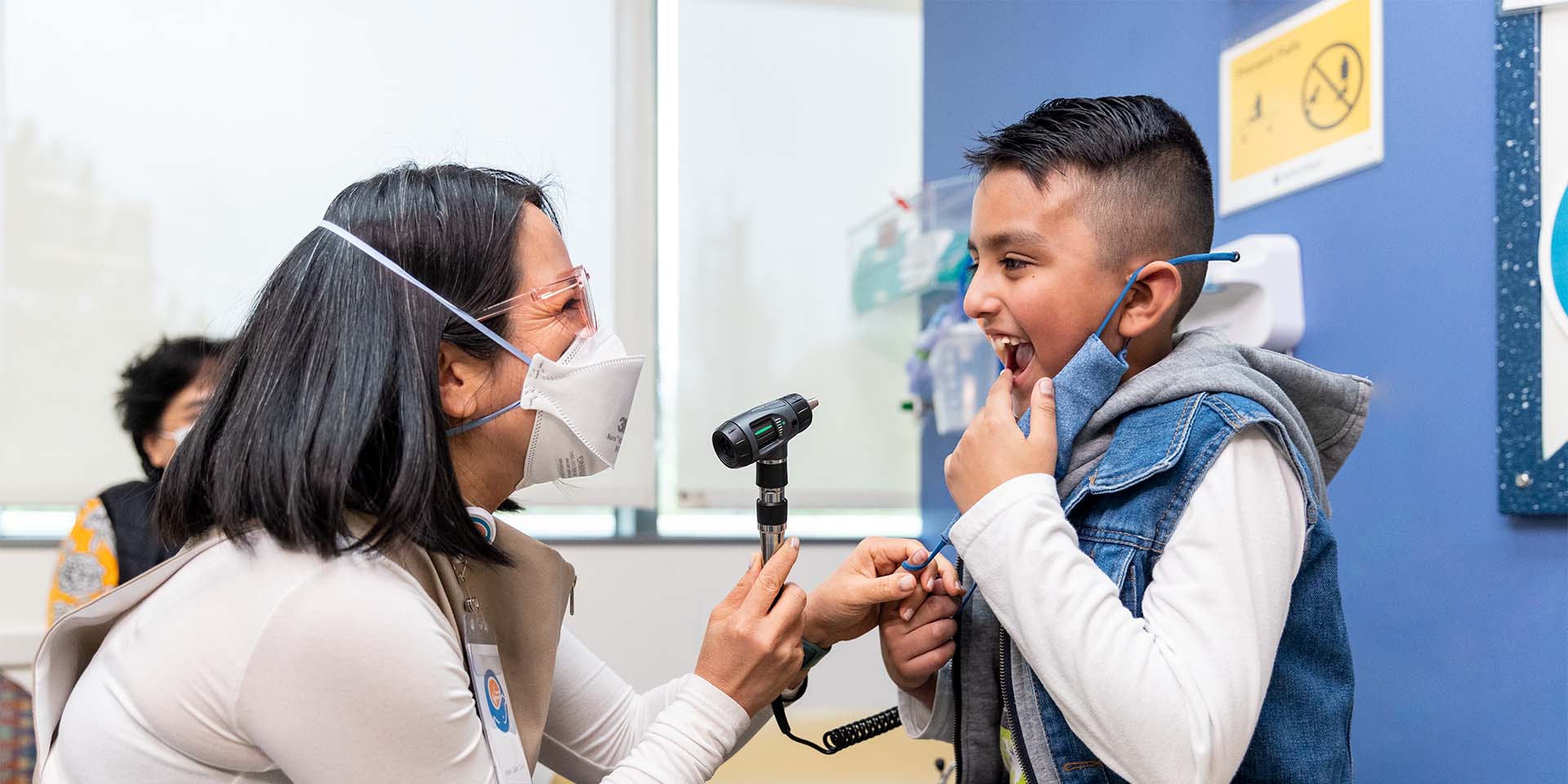 Masked Seattle Children's doctor examines a patient