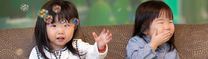 Charlotte and her sister Beatrice blowing bubbles