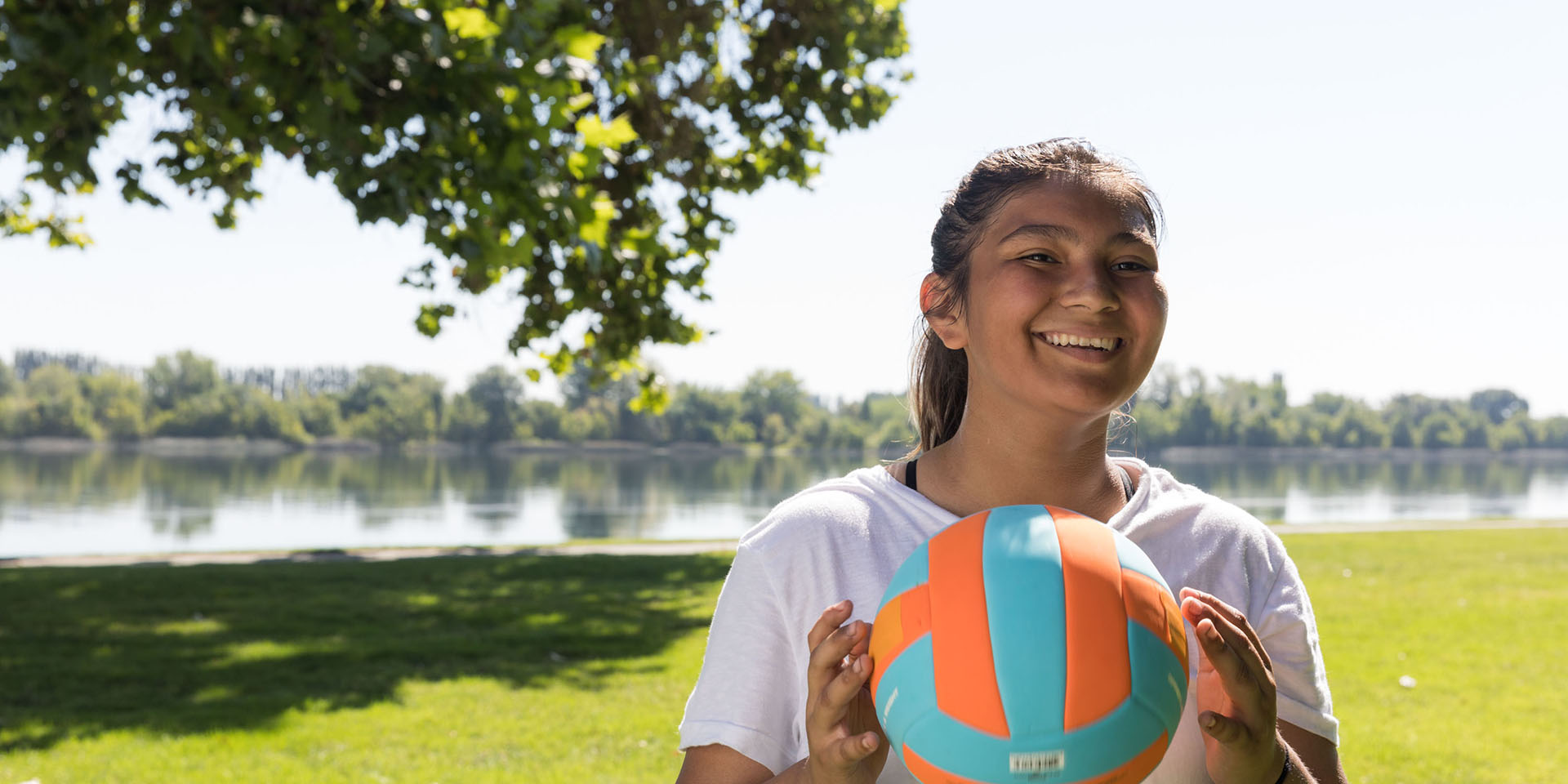 A girl holds a soccer ball