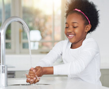 little girl washing her hands