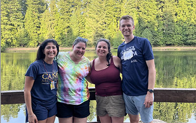 Four people pose for a picture outdoors