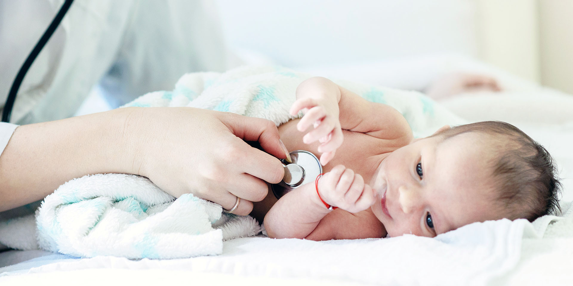 A baby being examined by a doctor