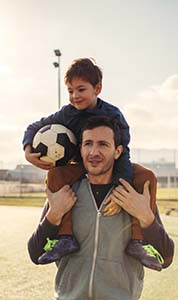 A boy on his father's shoulders